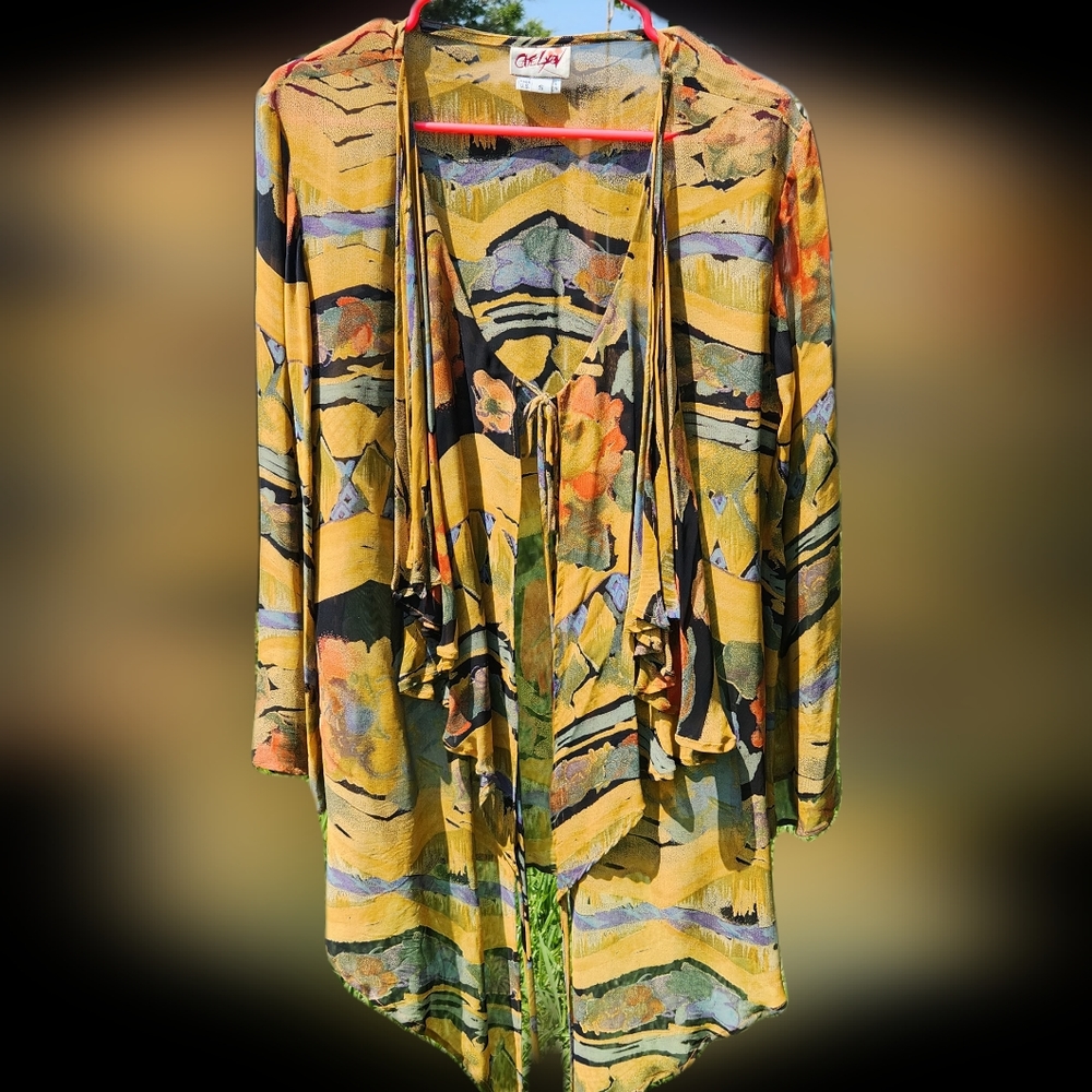 Silky top that ties in front. Wear over a bra top, tank, or tee. Flared sleeve.